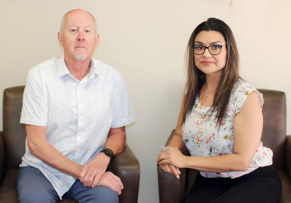 An office meeting between colleagues, emphasizing a professional relationship and dialogue.